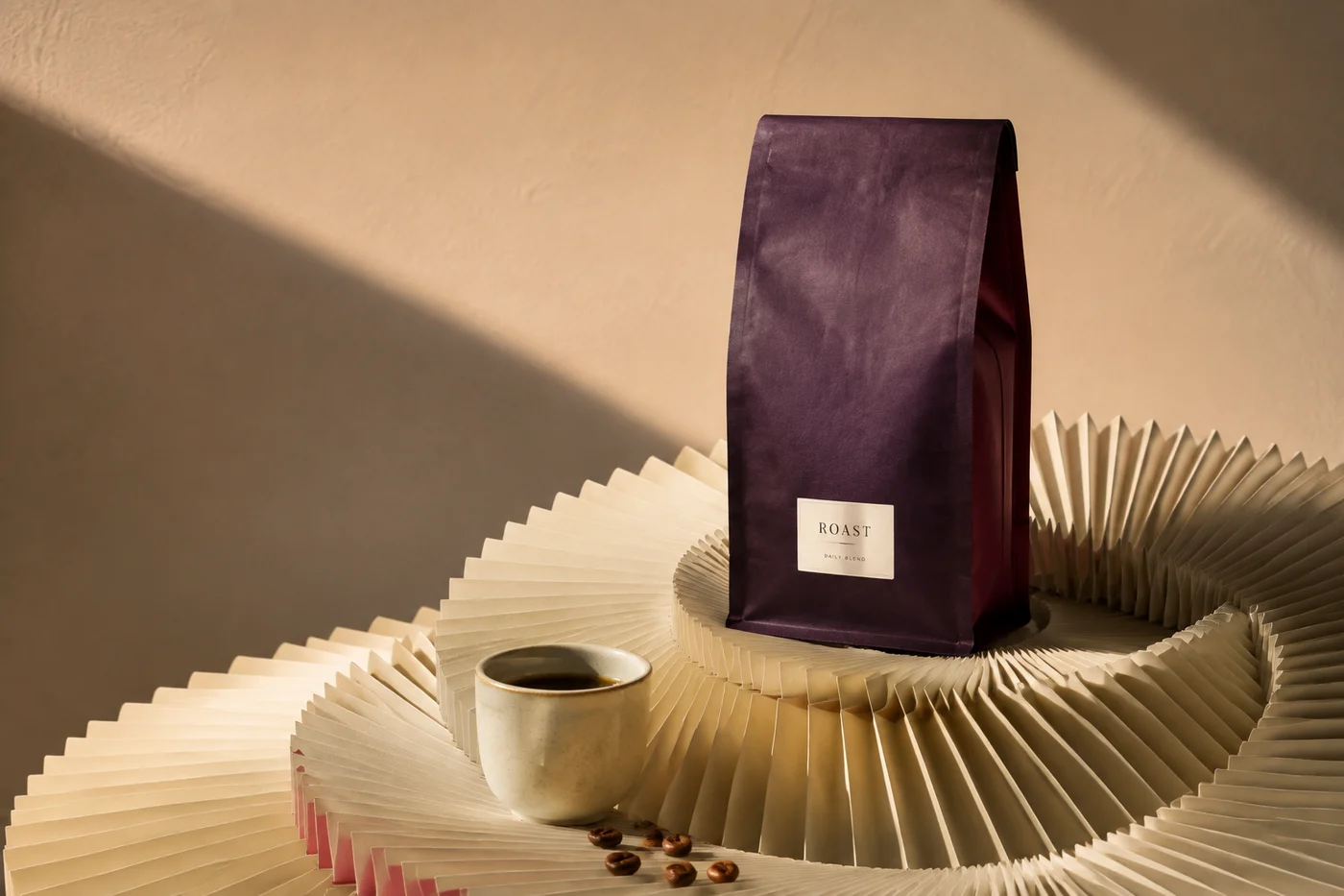 Plum coffee packaging and espresso on sculpted ivory paper